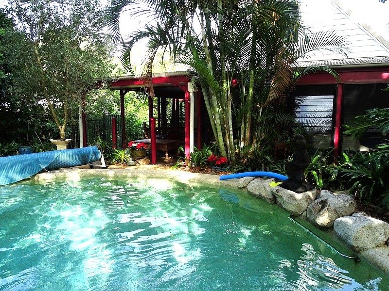 RARE FIND: Unique modernized double storey Queenslander with sparkling pool surrounded by rainforest garden in prime location